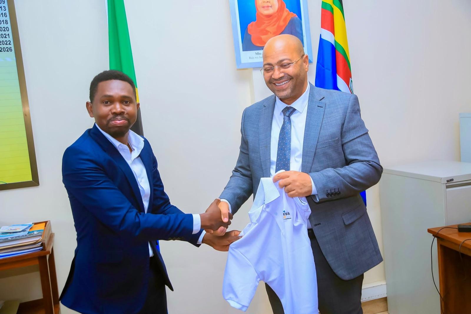Handshake and presentation of a Youth Business Forum polo shirt