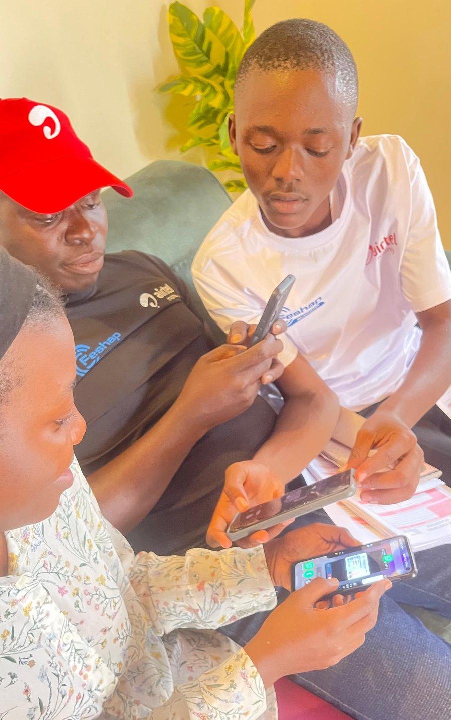 Feshap field team activating a customer on-site, phones and paperwork in hand